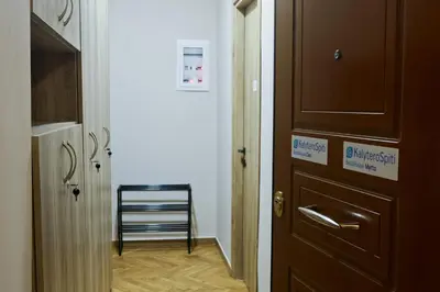 a hallway with a door and a chair in a room at Best House Cleo Pasalimani Piraeus in Piraeus
