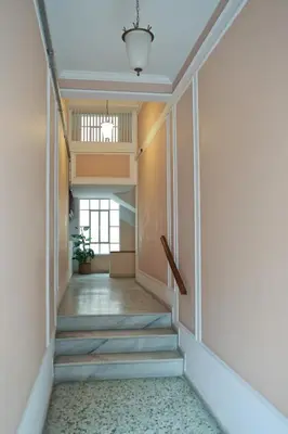 a hallway with stairs in an office building at Best House Cleo Pasalimani Piraeus in Piraeus