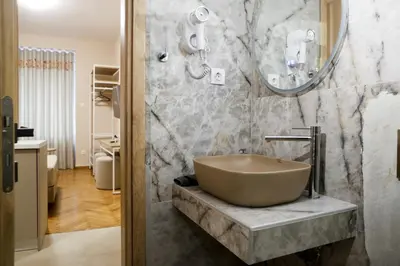 a bathroom with a bowl sink and a mirror at Best House Cleo Pasalimani Piraeus in Piraeus