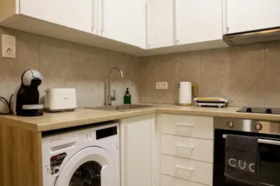 a kitchen with a washing machine and a sink at Best House Electra Pasalimani Piraeus in Piraeus