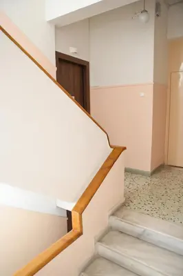 a stairwell in a building with a stair case at Best House Electra Pasalimani Piraeus in Piraeus