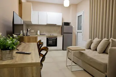 a kitchen and living room with a couch and a table at Best House Electra Pasalimani Piraeus in Piraeus