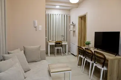 a living room with a couch and a table at Best House Electra Pasalimani Piraeus in Piraeus