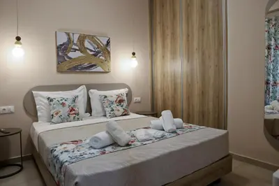 a bedroom with a bed with towels on it at Best House Electra Pasalimani Piraeus in Piraeus