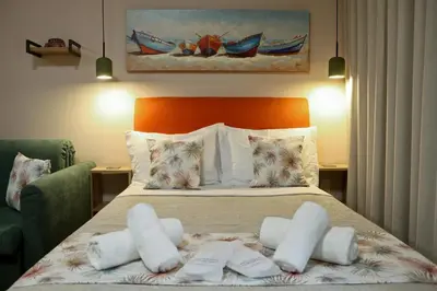 a bedroom with a bed with white towels on it at Best House Myrto Pasalimani Piraeus in Piraeus