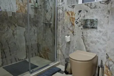 a bathroom with a shower and a toilet at Best House Myrto Pasalimani Piraeus in Piraeus