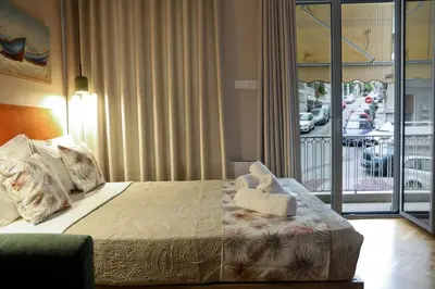 a bedroom with a bed with a view of a street at Best House Myrto Pasalimani Piraeus in Piraeus