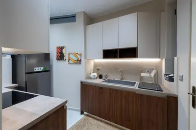 a kitchen with a sink and a refrigerator at Acropolis slow living apt - Ground floor in Athens