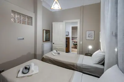 a hotel room with two beds and a mirror at Acropolis slow living apt - Ground floor in Athens