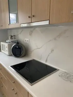 a kitchen counter with a sink and a microwave at Neapoli Modern Apartment in Athens