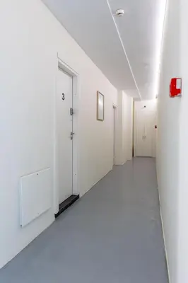 an empty hallway with white walls and white doors at Nobia 3 in Athens