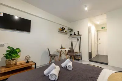 a bedroom with a bed and a tv on the wall at Nobia 3 in Athens