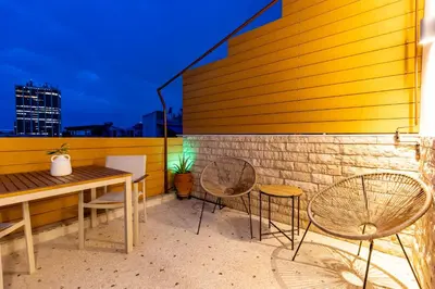 a patio with a table and chairs on a building at Eliá Designer Suite - Terraza Lycabettus y Lujo en Mesogeion in Athens