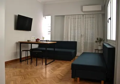 a living room with a table and a couch at Apollo & Nike 1952-2025 in Athens