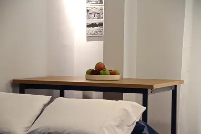 a table with a bowl of apples on top of it at Apollo & Nike 1952-2025 in Athens
