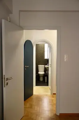 a hallway with a bathroom with a toilet and a door at Apollo & Nike 1952-2025 in Athens