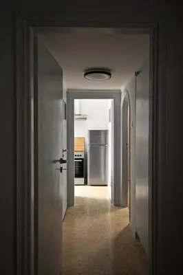 a hallway leading to a kitchen with a refrigerator at Apollo & Nike 1952-2025 in Athens