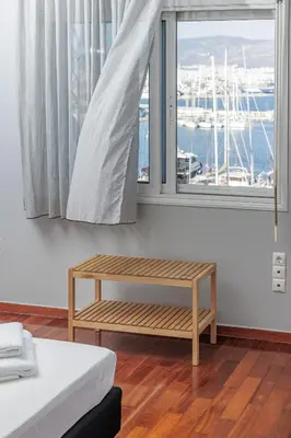a room with a bench in front of a window at Seaside Grey Pearl Villa in Piraeus