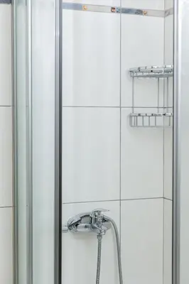 a shower with a faucet in a bathroom at Seaside Grey Pearl Villa in Piraeus