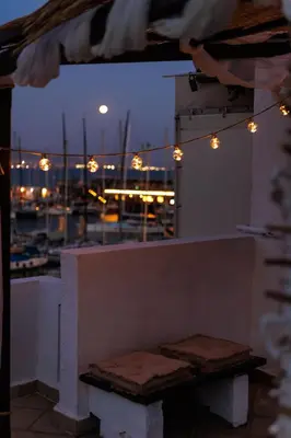 a bench on a balcony with a view of a harbor at Seaside Grey Pearl Villa in Piraeus