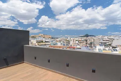 a balcony with a view of a city at Chic 1-Bedroom Apartment with balcony by WeHost Athens in Athens