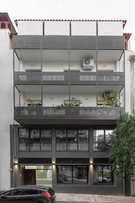 a black car parked in front of a building at Chic 1-Bedroom Apartment with balcony by WeHost Athens in Athens