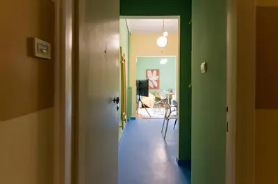 a hallway with green walls and a dining room at Whispering Walls Premium 1 bedroom Apartment in Athens