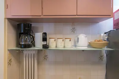a shelf in a kitchen with appliances on it at Whispering Walls Premium 1 bedroom Apartment in Athens