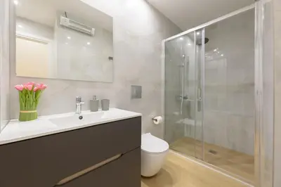 a bathroom with a toilet and a sink and a shower at Bright 1-Bedroom Apartment by WeHost Athens in Athens