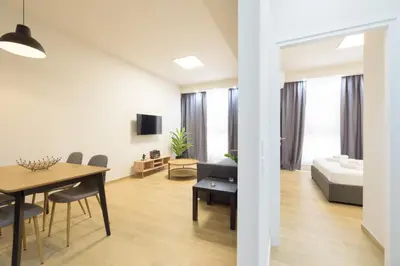 a living room with a dining table and a bedroom at Bright 1-Bedroom Apartment by WeHost Athens in Athens