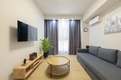 a living room with a couch and a table at Bright 1-Bedroom Apartment by WeHost Athens in Athens