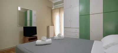 a bedroom with a bed with two white towels at Down Town Flat Apartment in Athens