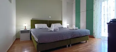 a bedroom with a bed with two pillows on it at Down Town Flat Apartment in Athens