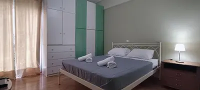 a bedroom with a bed with two pillows on it at Down Town Flat Apartment in Athens