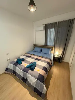 a bedroom with a bed with blue pillows on it at AtticHub in Athens