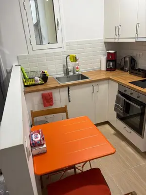 an orange bench in a kitchen with a sink at AtticHub in Athens