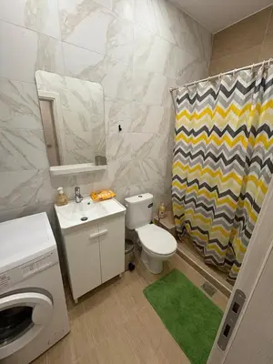 a bathroom with a toilet and a sink and a shower curtain at AtticHub in Athens
