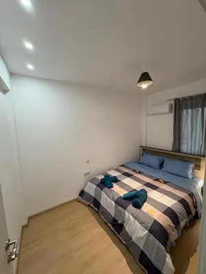 a bedroom with a bed with a checkered blanket at AtticHub in Athens