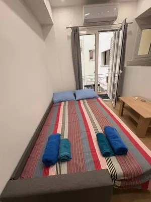 a large bed with blue pillows in a room at AtticHub in Athens