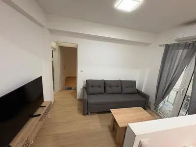 a living room with a couch and a table at AtticHub in Athens