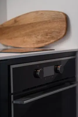 a wooden cutting board sitting on top of a stove at Chic Urban Suite - Parthenon Viewpoint in Athens