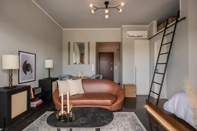 a living room with a couch and a loft bed at Chic Urban Suite - Parthenon Viewpoint in Athens