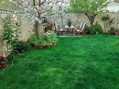 a garden with a table and chairs and flowers at Near the Airport & near the Metro and Suburban station