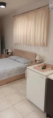 a bedroom with a bed with a window and a table at Near the Airport & near the Metro and Suburban station