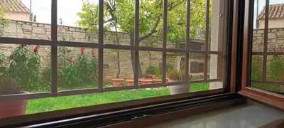 a window view of a garden with potted plants at Near the Airport & near the Metro and Suburban station