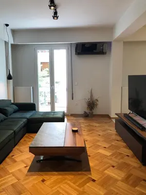 a living room with a couch and a coffee table at 3 BD apart in the center of Athens 2min from metro in Athens