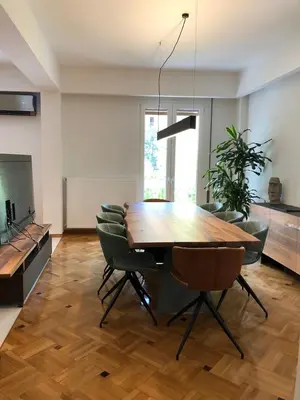 a dining room with a wooden table and chairs at 3 BD apart in the center of Athens 2min from metro in Athens