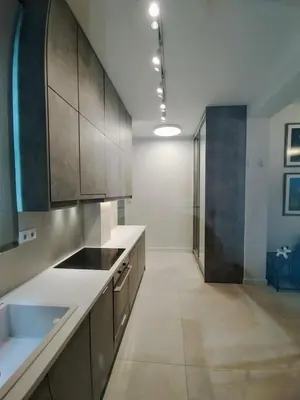 a kitchen with wooden cabinets and a sink and a bathroom at AMG Superior Central Apartment sleeps up to 5 in Athens