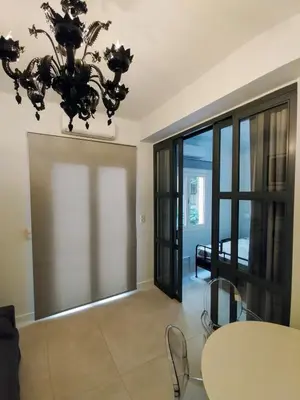 a dining room with a table and a chandelier at AMG Superior Central Apartment sleeps up to 5 in Athens