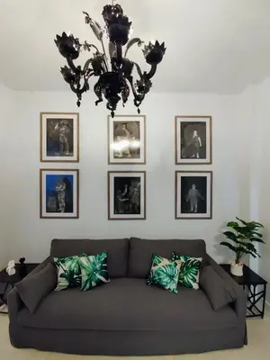 a living room with a couch and pictures on the wall at AMG Superior Central Apartment sleeps up to 5 in Athens
